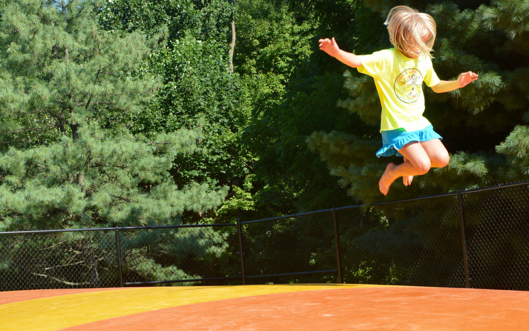 A child in the air after jumping on the Little Bennett Campground Jumping Pillow
