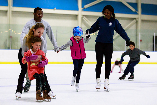children and staff learning to ice skate