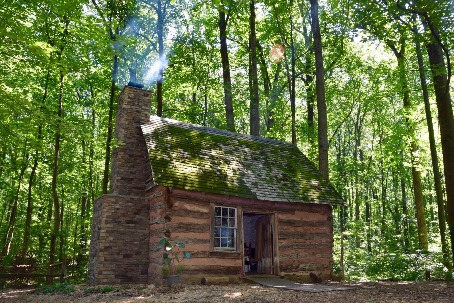 Smoke rises from the Harper Homestead log cabin. 