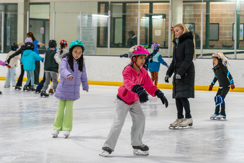 Skaters having a group lesson with a skating instructor