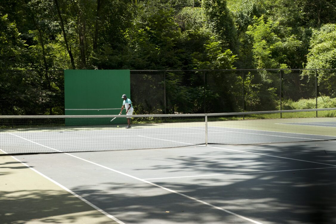 Patron playing in the Tennis court at Dale Drive Neighborhood Park