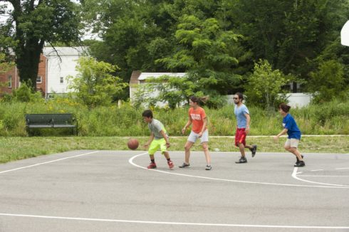 Adults and Children playing Basketball at Evans Parkway Neighborhood Park