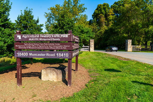 The brown wood sign for the farm park on Muncaster rd with the name and address of the park 