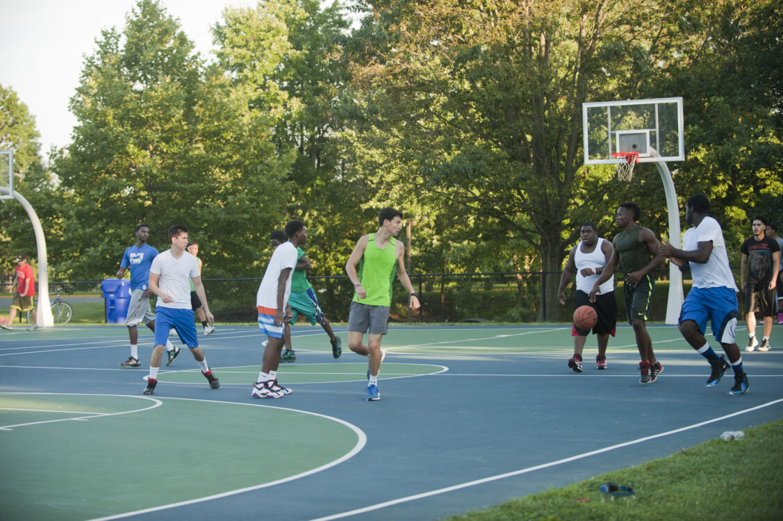 Patrons playing basketball at Martin Luther King Jr. Recreational Park