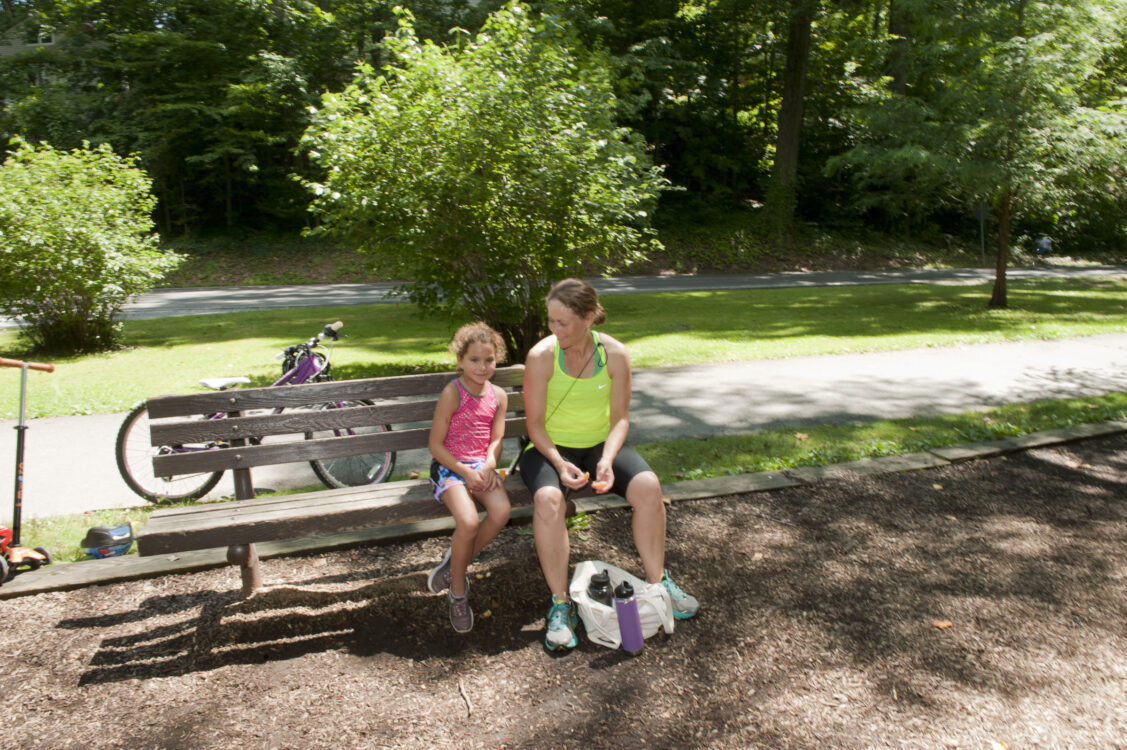 Visitors sitting on bench at Sligo Creek North Neighborhood Park