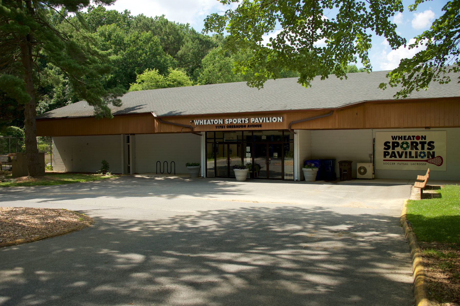 Front entrance to Wheaton Sports Pavilion with trees surrounding the building