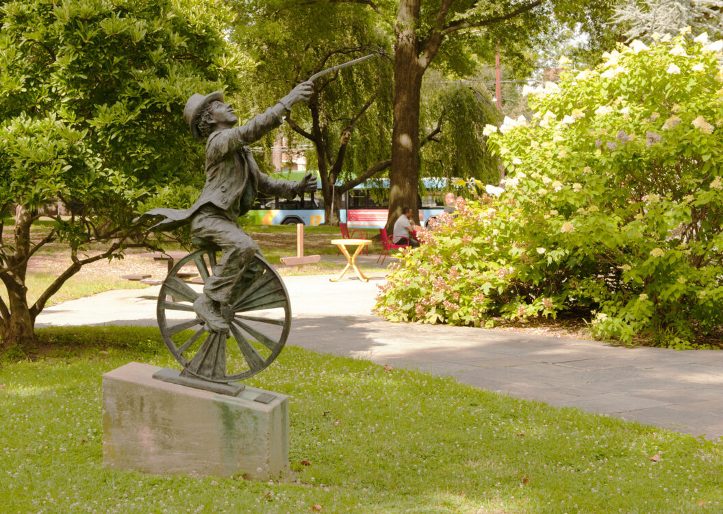 statue of a colonial man riding a unicycle at Woodside Urban Park