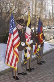 Uniformed officer surrounded by flags