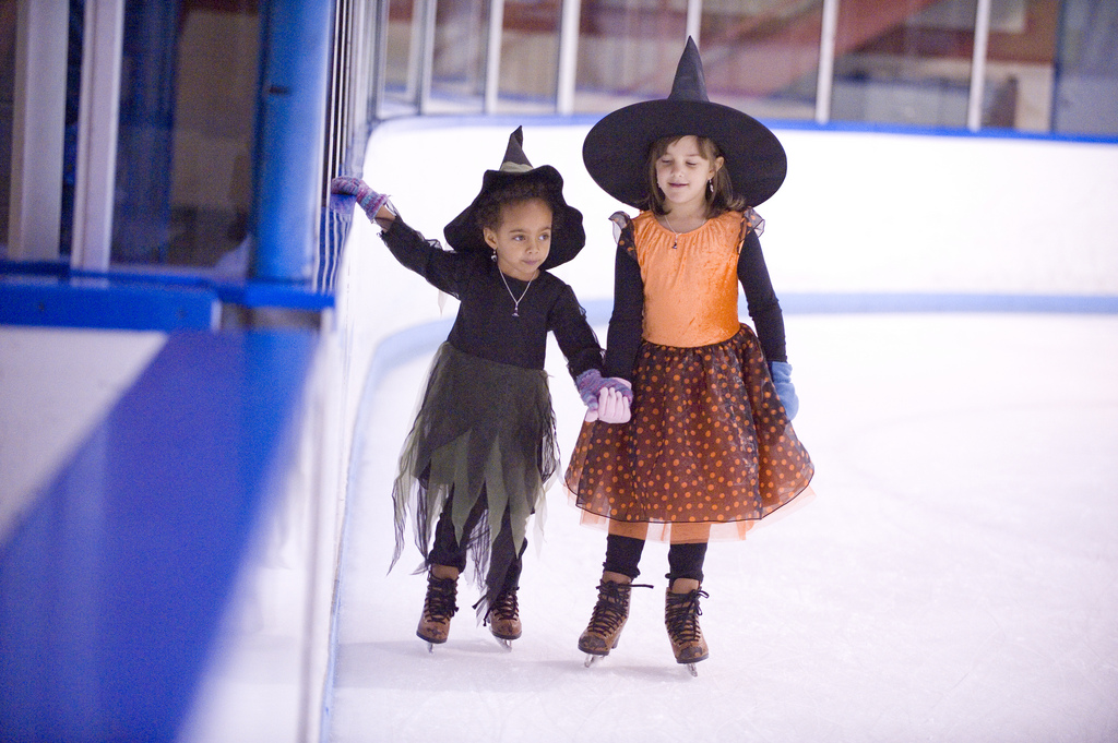 two skaters in witch costumes