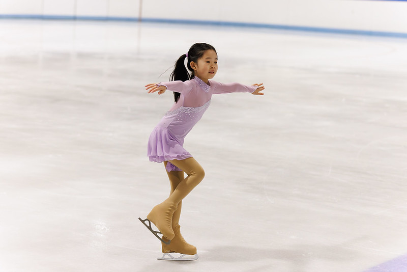 Skater performing one foot glide in the ice show