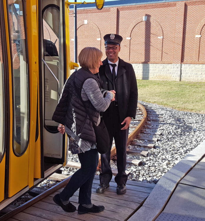 train conductor and visitor at National Capital Trolley Museum