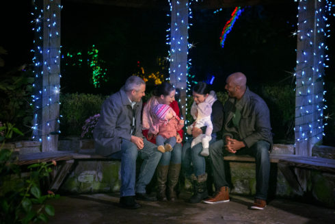 A family in a gazebo with lights