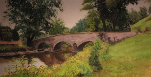 Image of a painted bridge in a forest setting