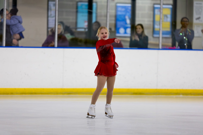 Girl in red dress dancing in the ice show