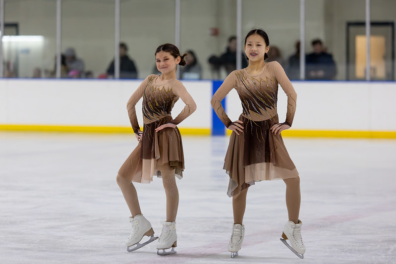 Two girls skating together in the ice show