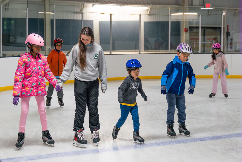 Counselor and campers skating