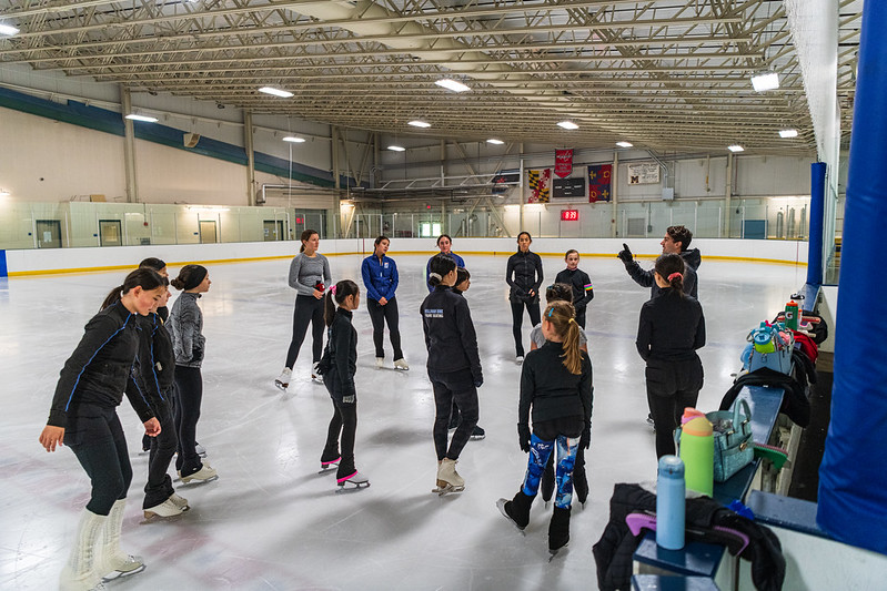 Max explaining a drill on the ice to the skaters