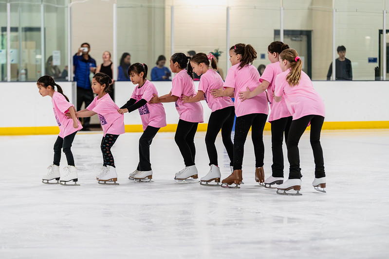 Skaters making a train on the ice