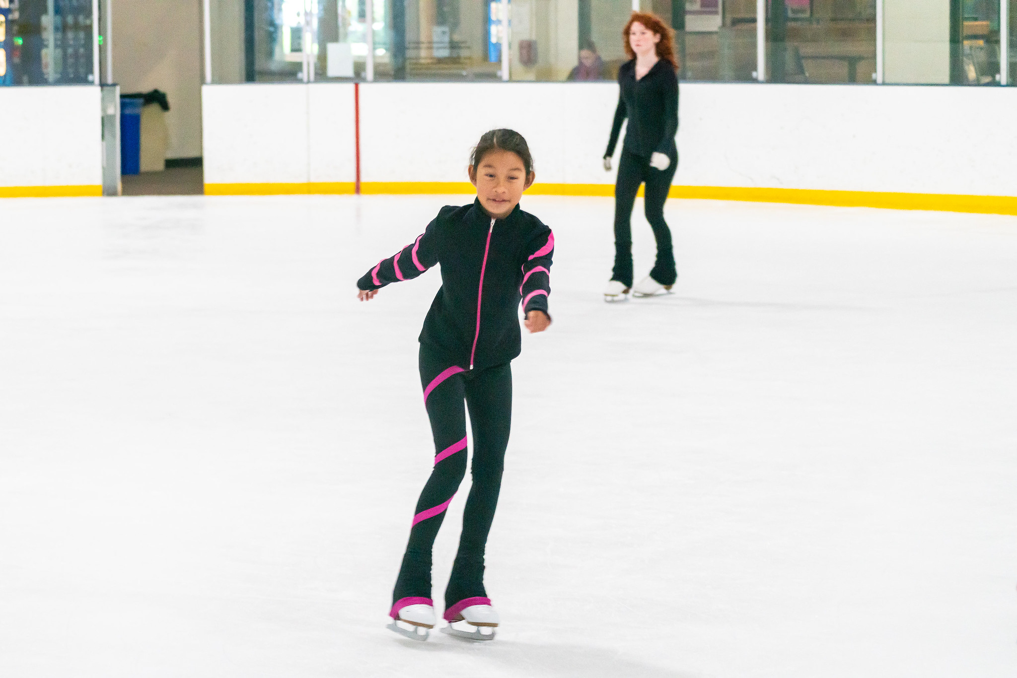 child about to perform an axel on the ice