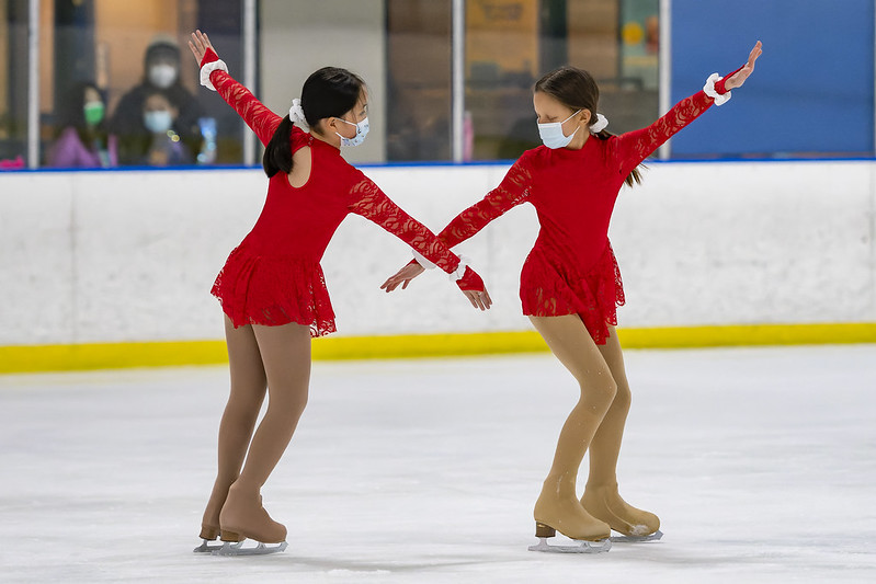 Two figure skaters in red