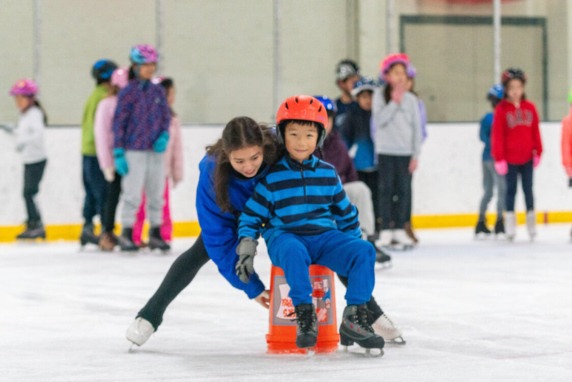 child learning how to skate at theater camp