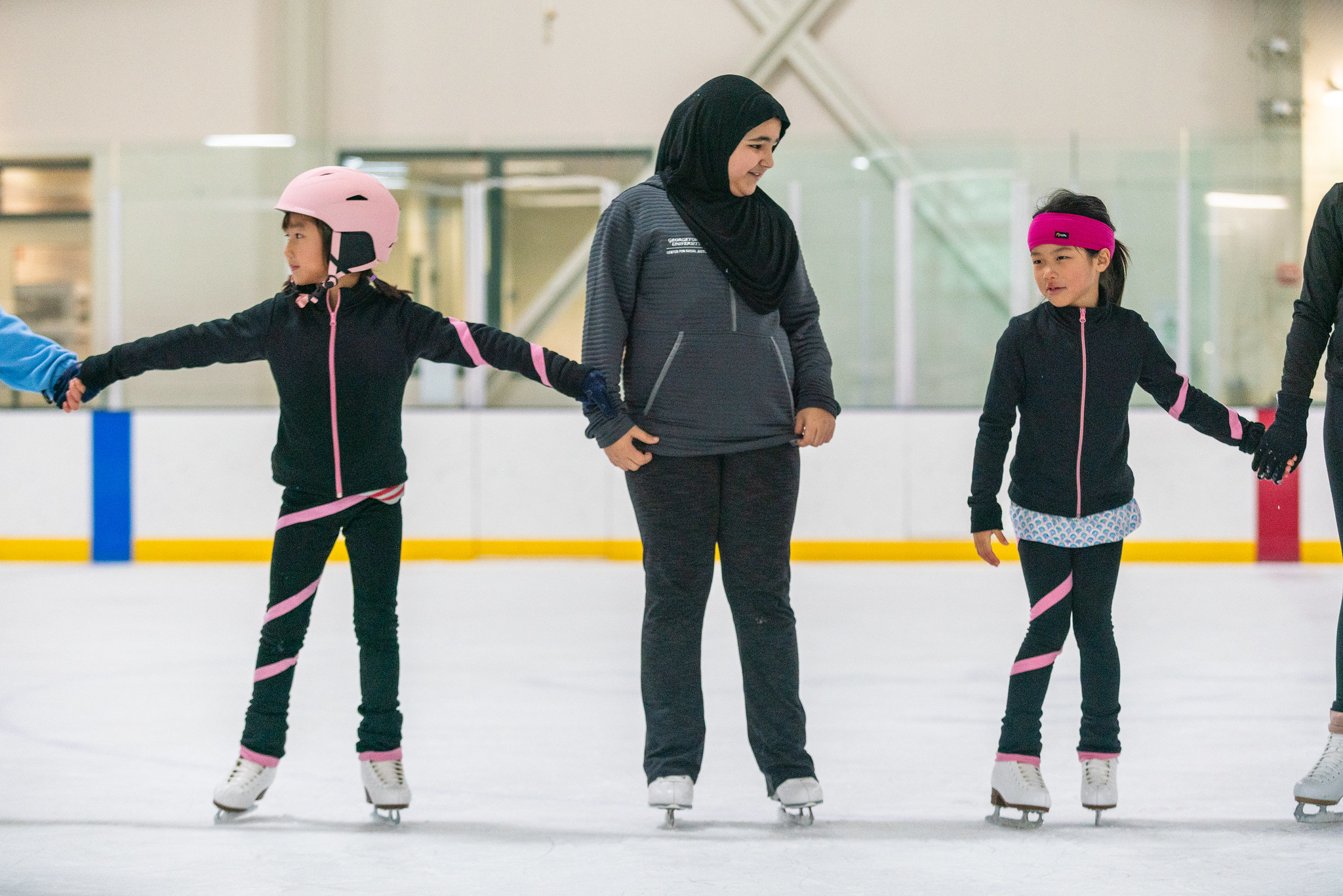 children holding hands learning how to skate at theatre camp