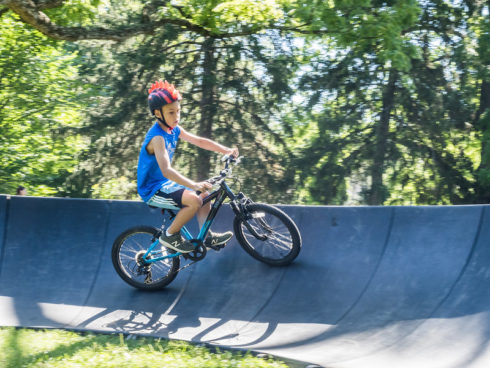 boy on a bicycle riding on a pump track