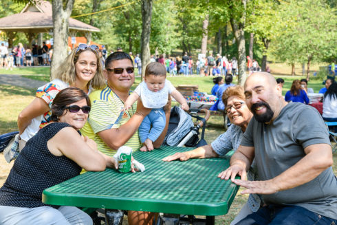 group of people sitting at a picnic table