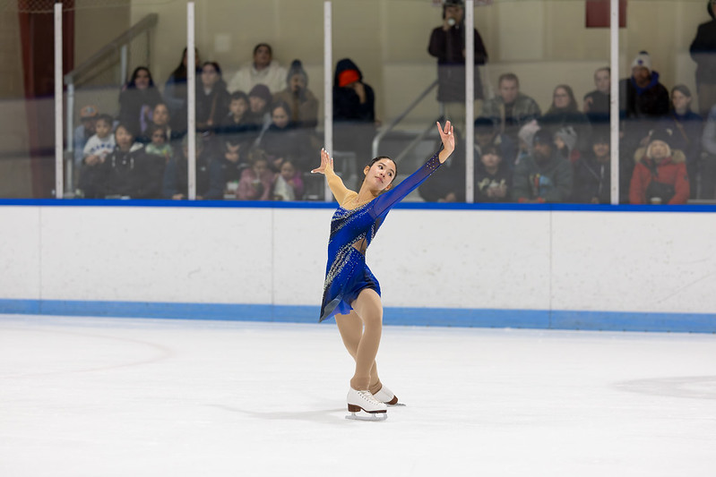 Girls in blue dress performing in ice skating show