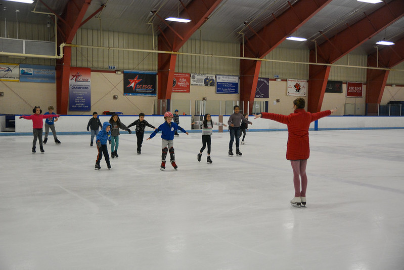 Instructor teaching ice skating class
