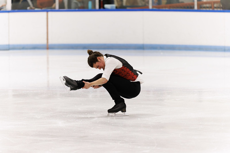 Man performing a sit spin in the ice show