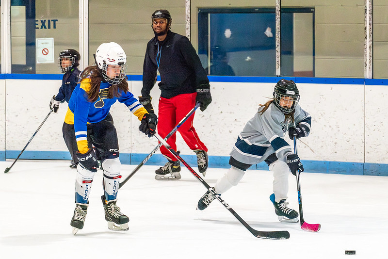 Hockey coach with hockey players on the ice