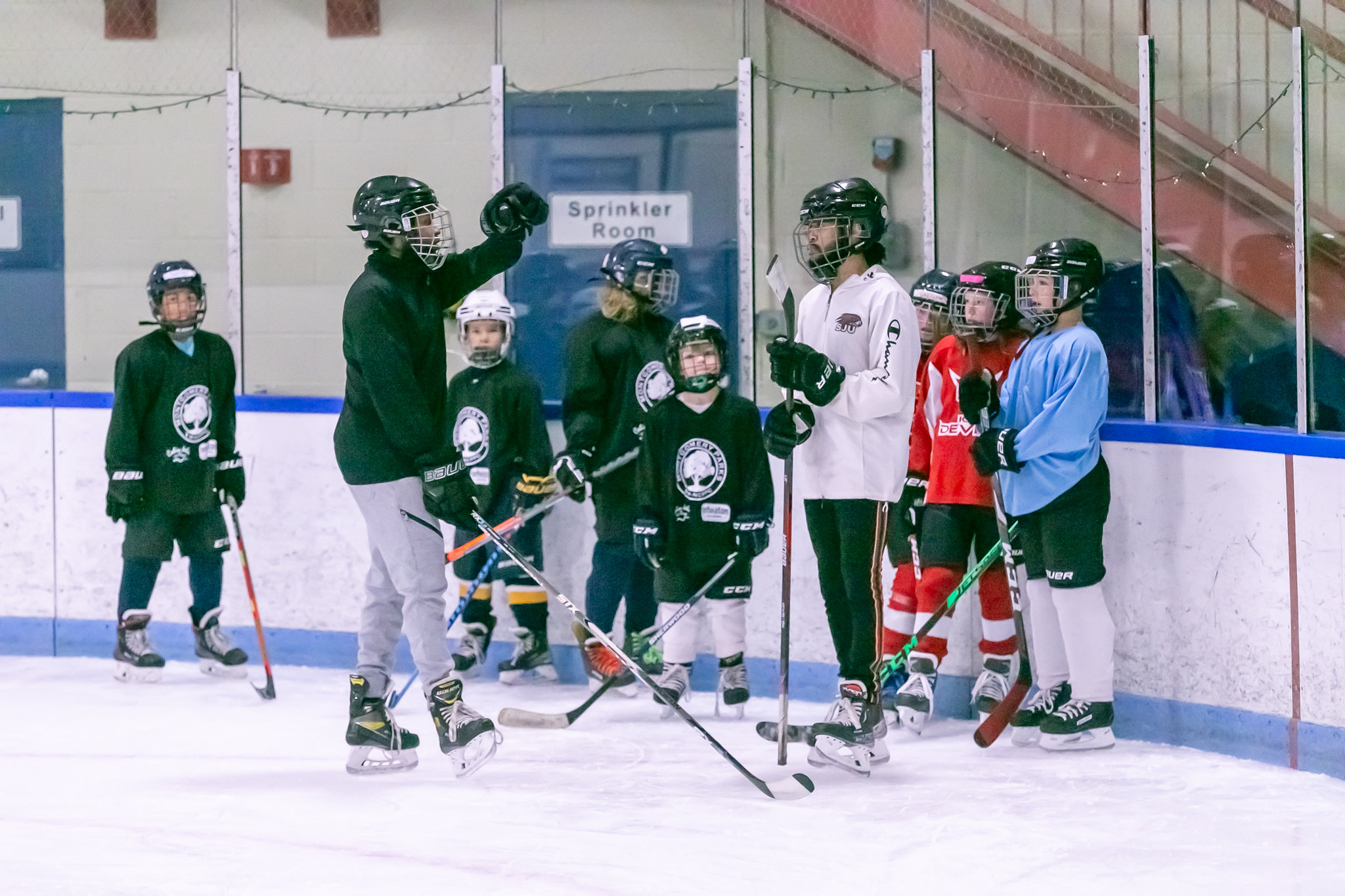 hockey coach giving instruction to players