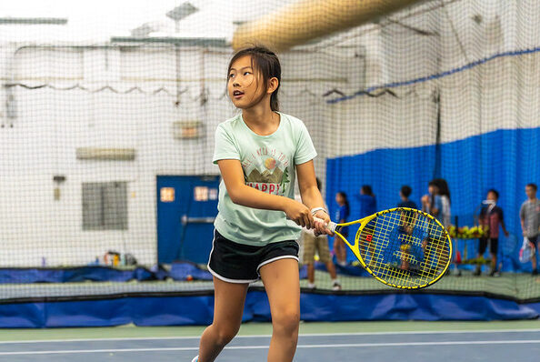 girl playing tennis