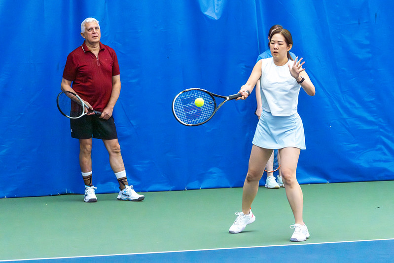 Two adults playing tennis