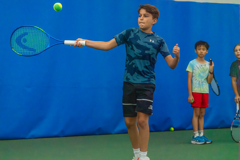 Boy hitting a tennis ball