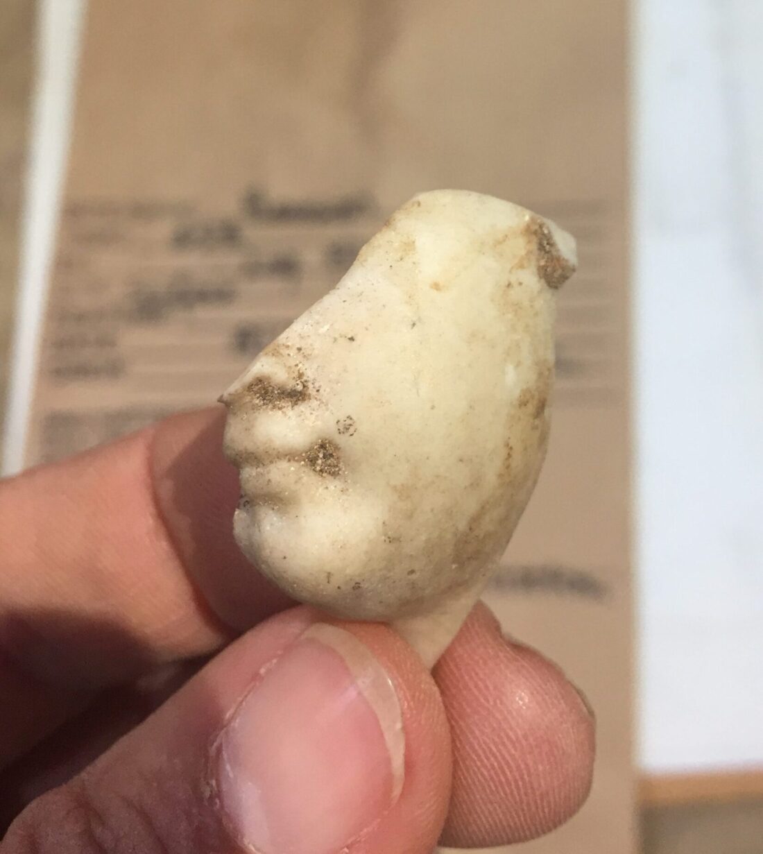 Excavated porcelain doll face from Josiah Henson log kitchen