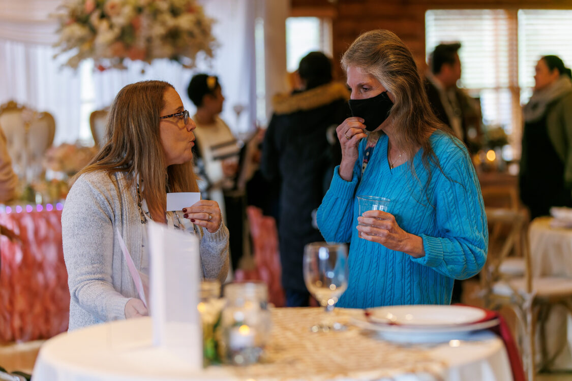 two people viewing place setting Seneca Lodge Winter Open House