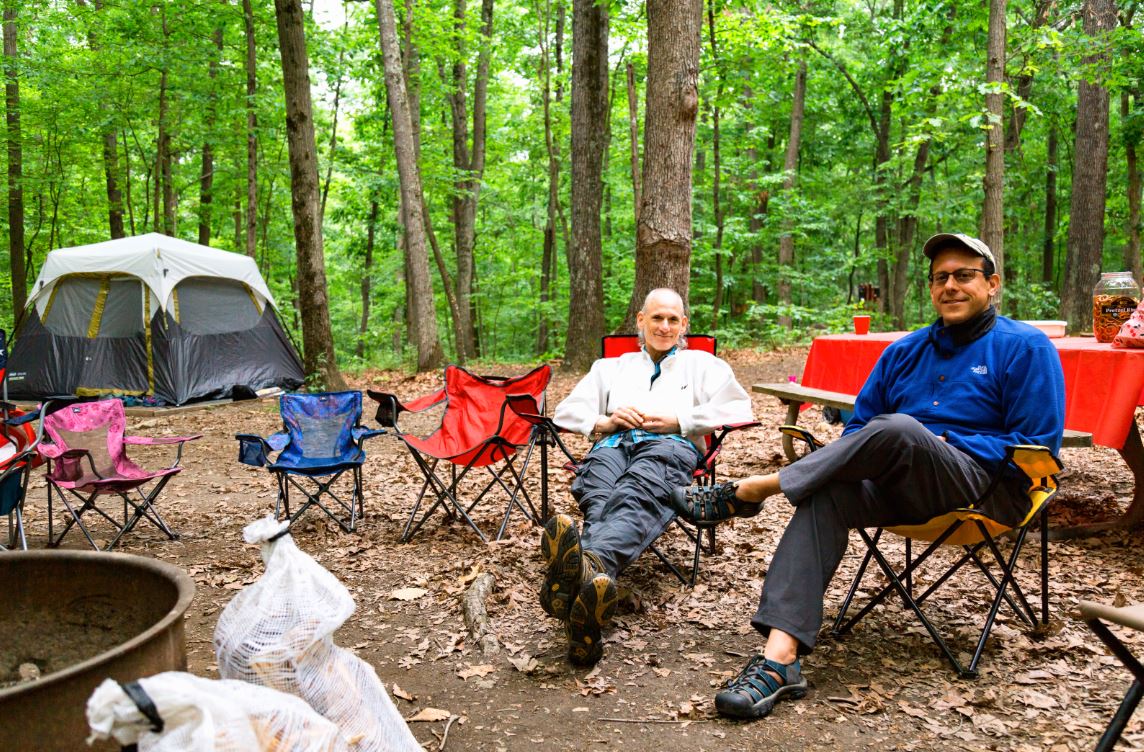 campers sitting by campfire