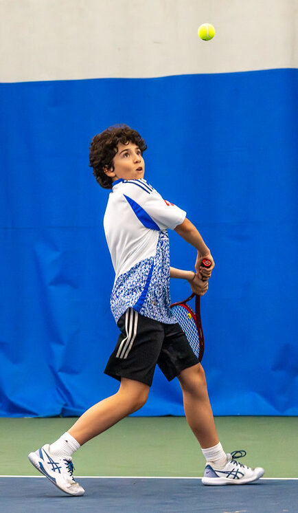 boy playing tennis
