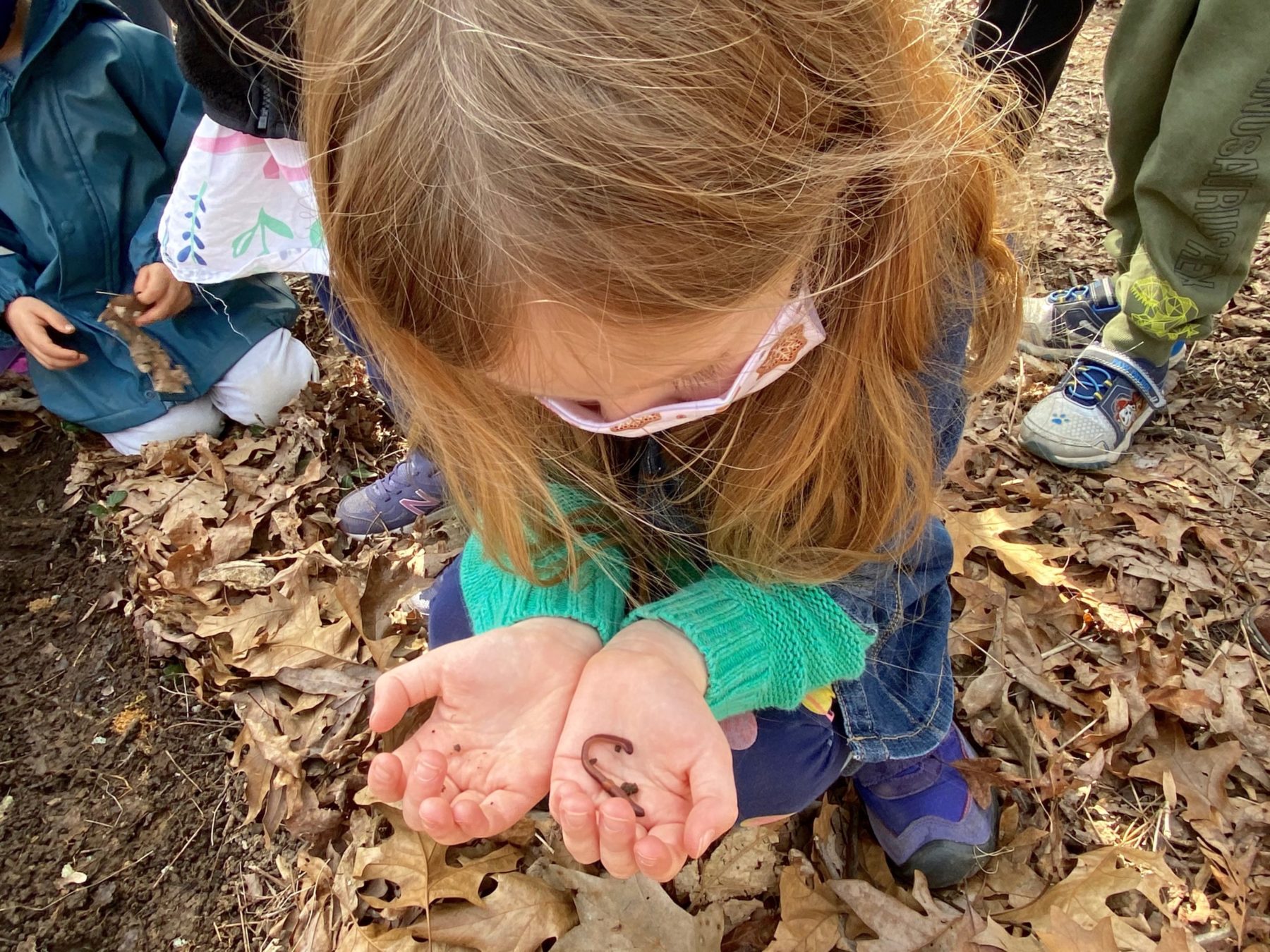 Young child holding worm at Maydale Nature Classroom