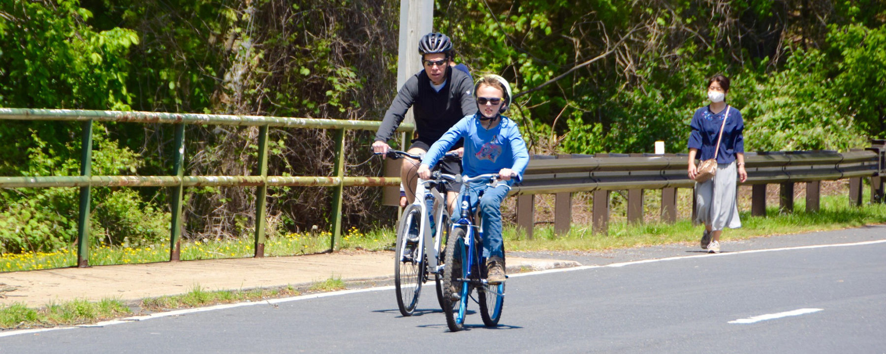 Photo of Man and younger boy riding bikes on the Open Parkways in MOntgomery County
