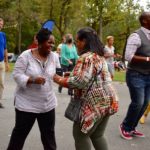 Two friends dancing and laughing at Salsa in the Park