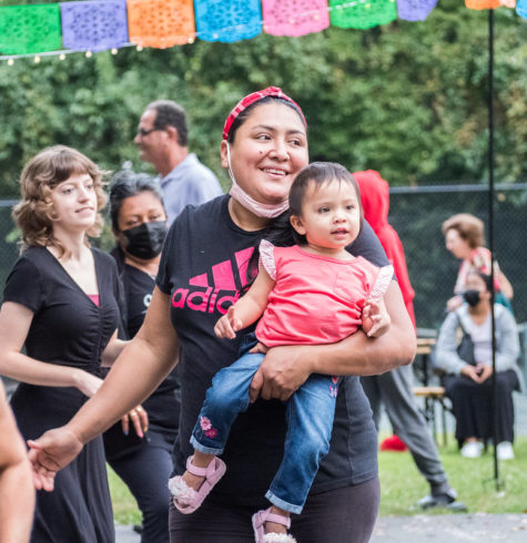 Mother dancing with her baby at Salsa in the Park