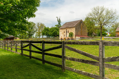 The stone barn, pasture, and fence at Woodlawn Manor Cultural Park.