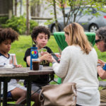kids playing cards at picnic table