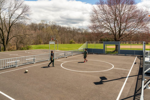 People playing soccer on a futsal court