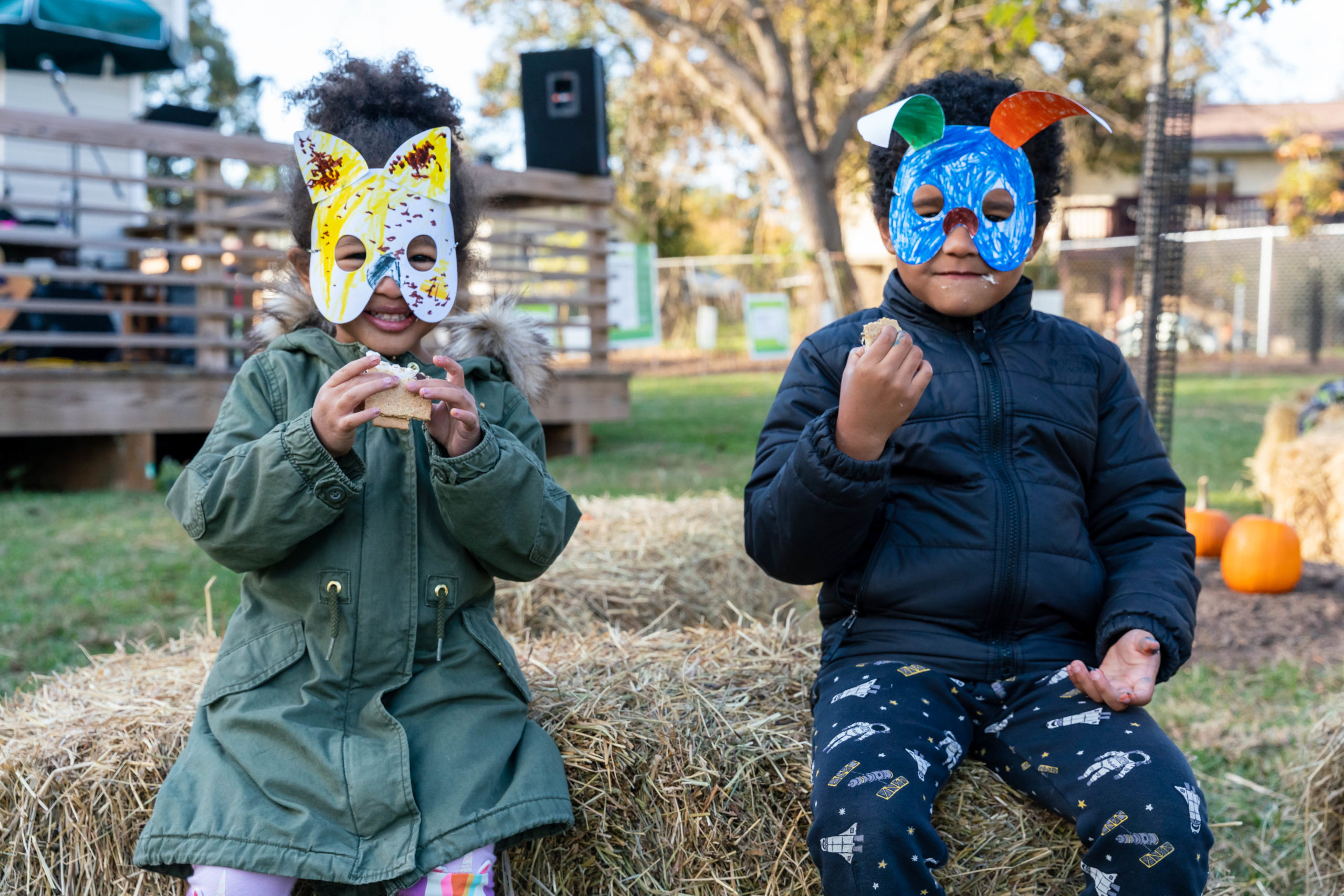 two children wearing animals masks