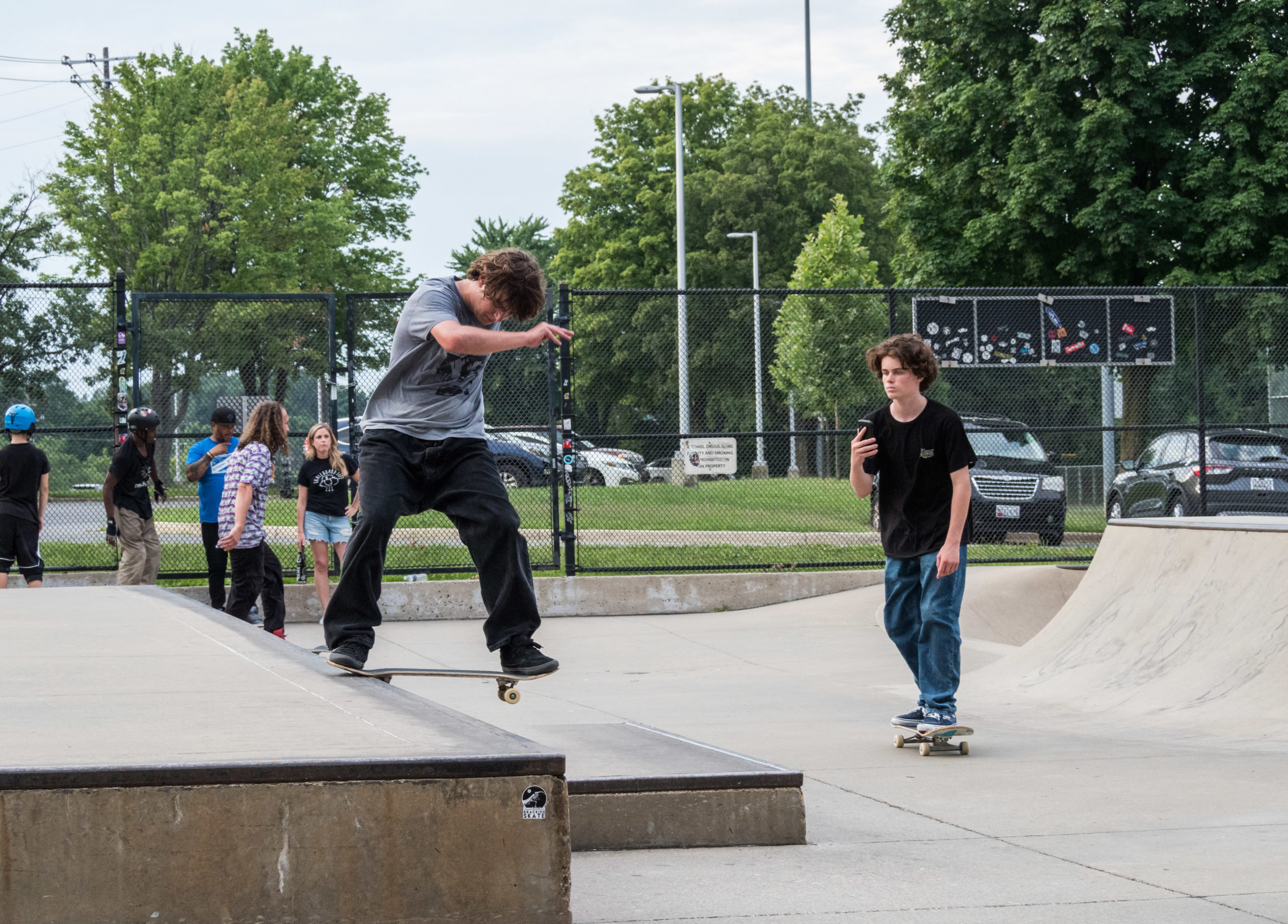 two kids skating in skate park