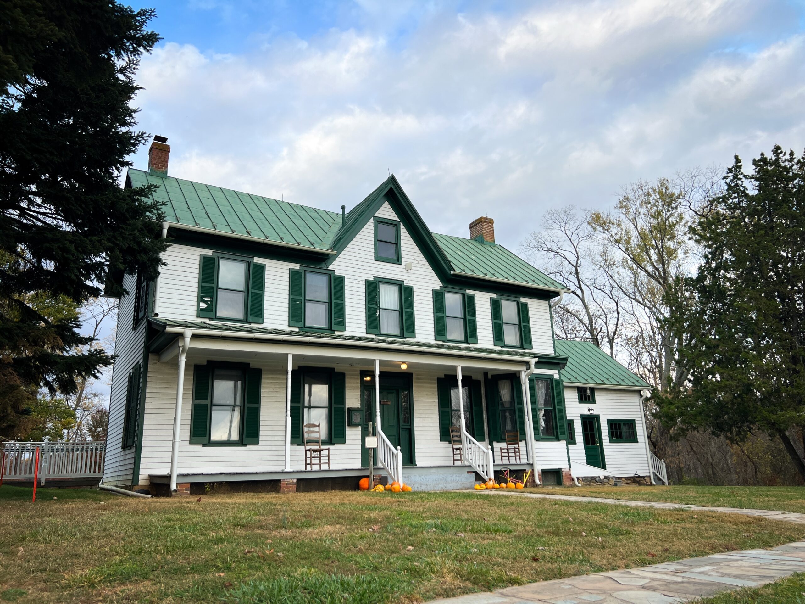 Farmhouse in fall with pumpkins